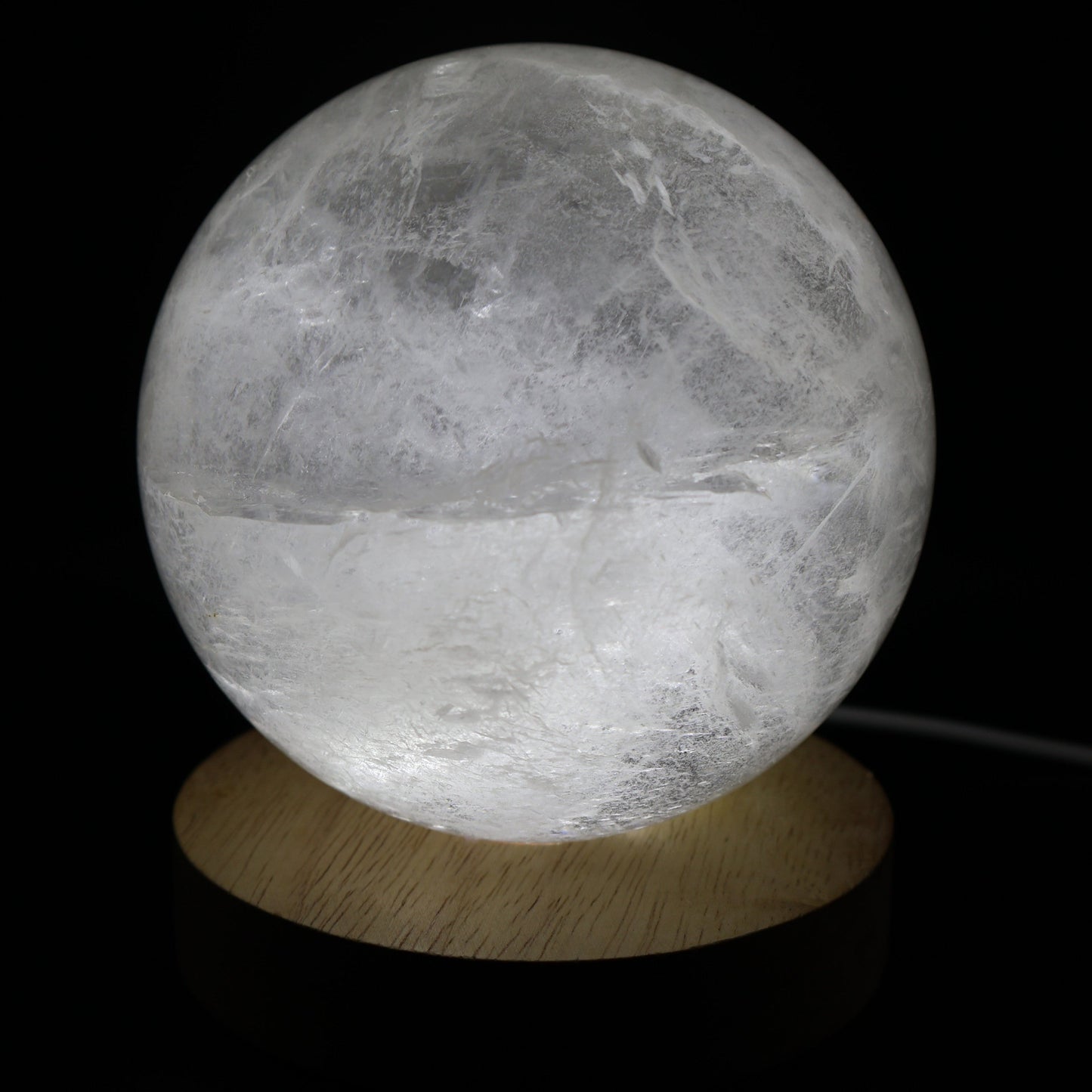 Large White Calcite sphere with soft white colouring, natural inclusions and internal rainbow flashes, 10cm diameter and weighing 1.624kg.