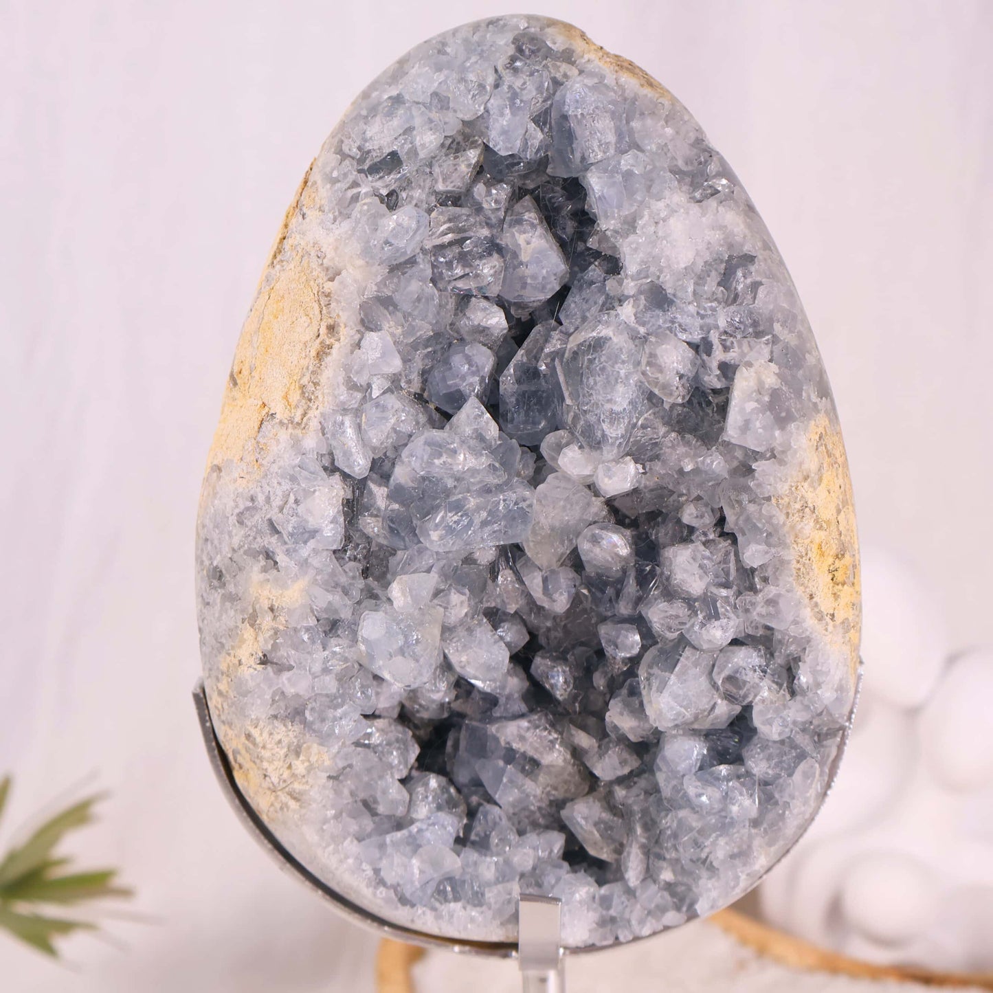 large blue celestite cluster on stand