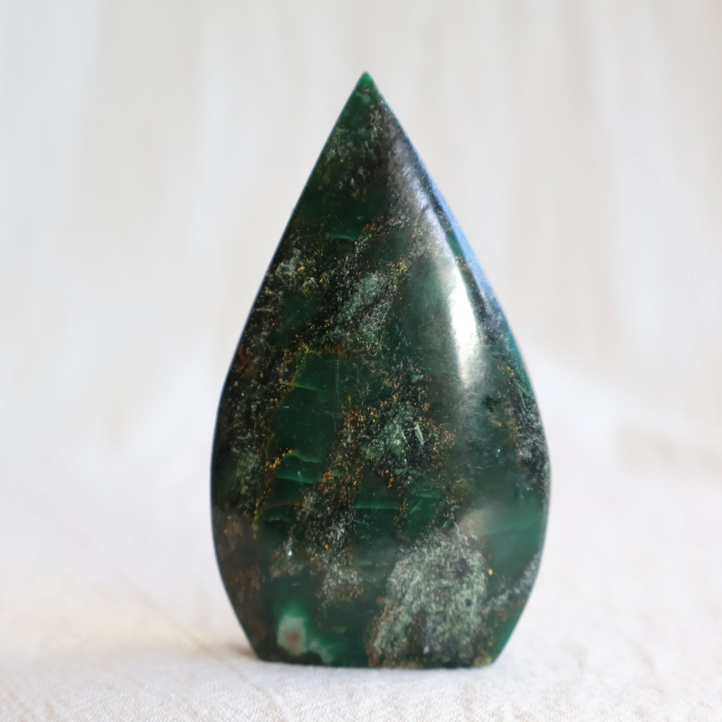 Natural Emerald crystal freeforms with deep green colouring, earthy inclusions and polished modern freeform shapes.