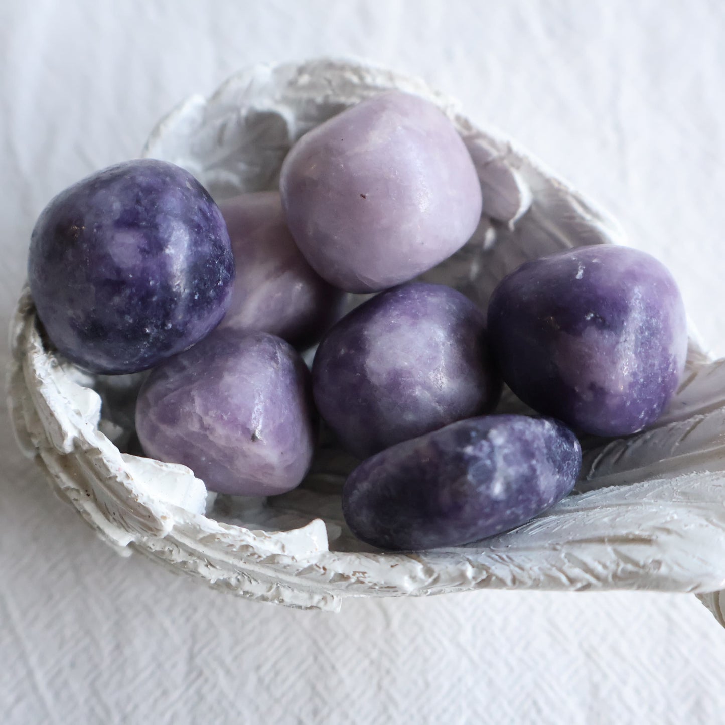 Polished Lepidolite crystal tumble in natural lilac, purple and creamy white tones with unique patterning.