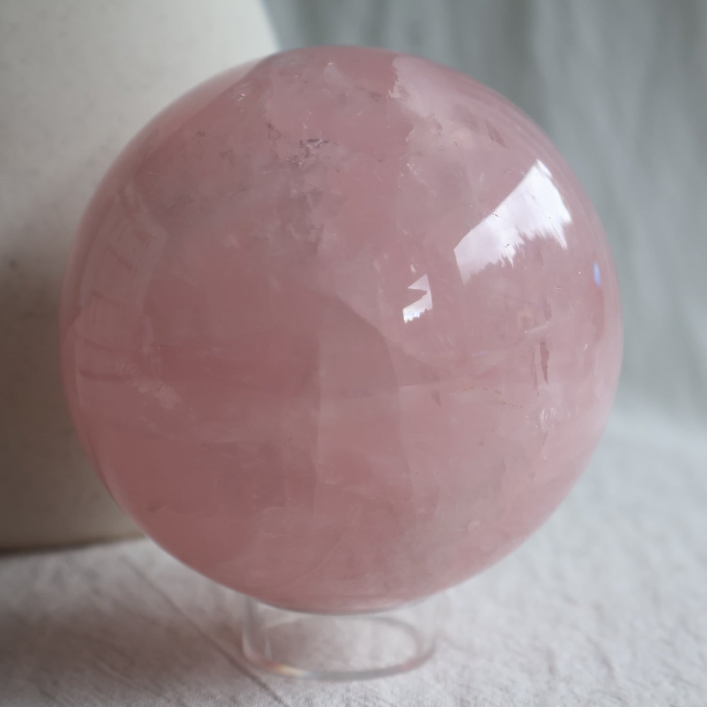XL Rose Quartz sphere with soft blush pink colour, translucent areas and natural internal veils, polished 8.5cm crystal sphere weighing 930g