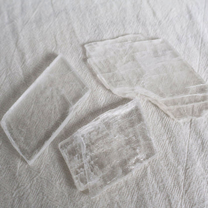Three rectangular glass coasters on a textured gray surface