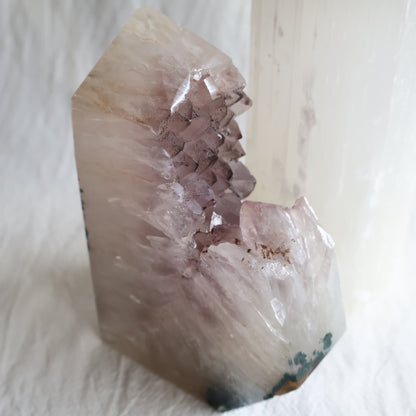 Amethyst polished point with exposed crystal clusters and dark mineral inclusions across the tips, measuring 13cm tall and weighing 778g.