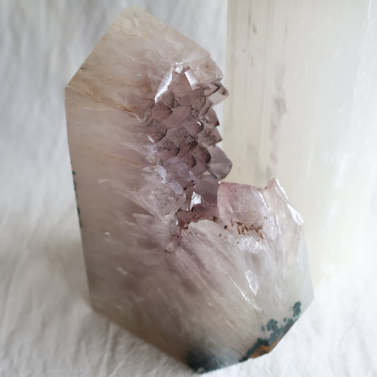 Amethyst polished point with exposed crystal clusters and dark mineral inclusions across the tips, measuring 13cm tall and weighing 778g.