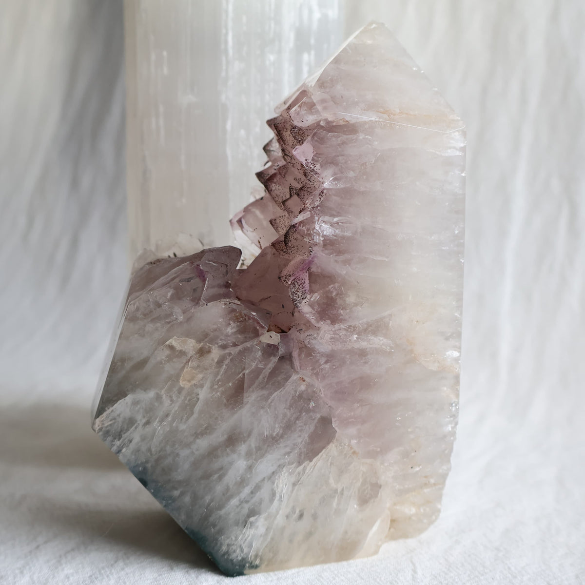 Amethyst polished point with exposed crystal clusters and dark mineral inclusions across the tips, measuring 13cm tall and weighing 778g.