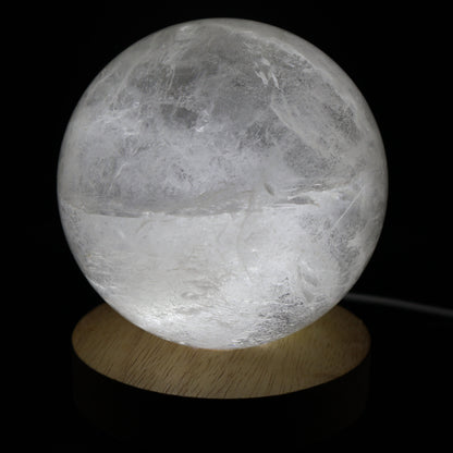 Large White Calcite sphere with soft white colouring, natural inclusions and internal rainbow flashes, 10cm diameter and weighing 1.624kg.