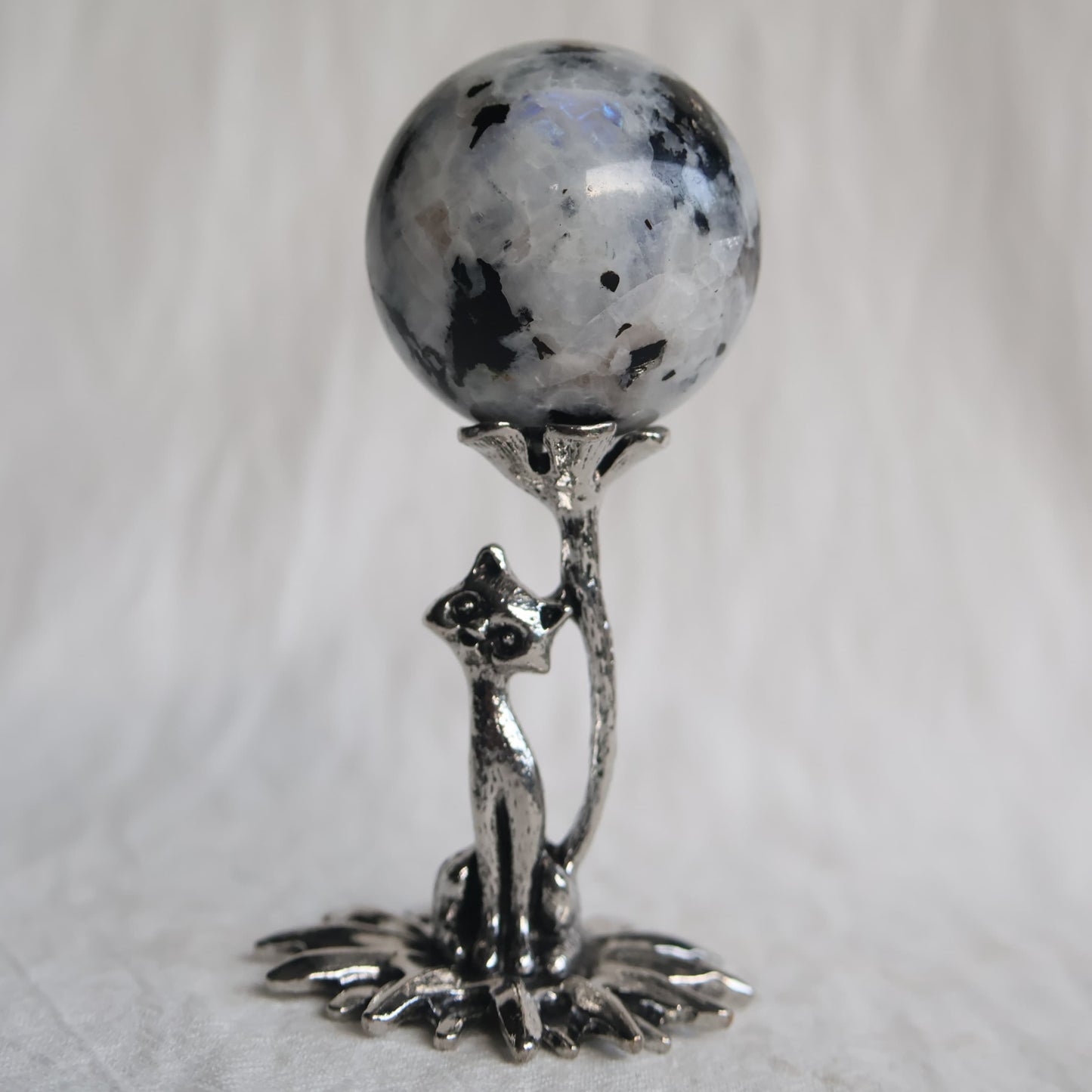 Silver-coloured metal cat sphere stand featuring a cat reaching towards a flower, designed to hold crystal spheres up to 4cm in size.