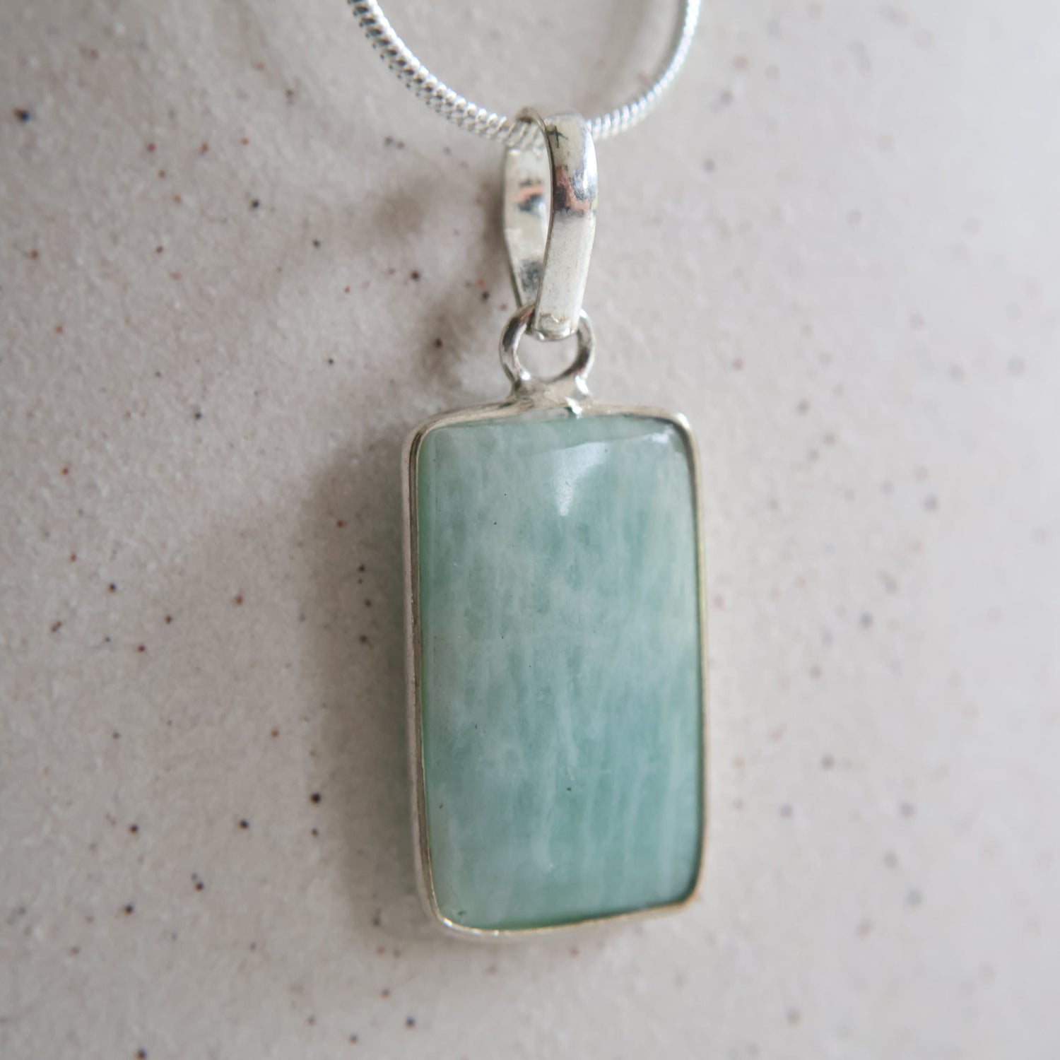Amazonite crystal pendant with soft green tones and wrapped s925 silver border, exact piece shown
