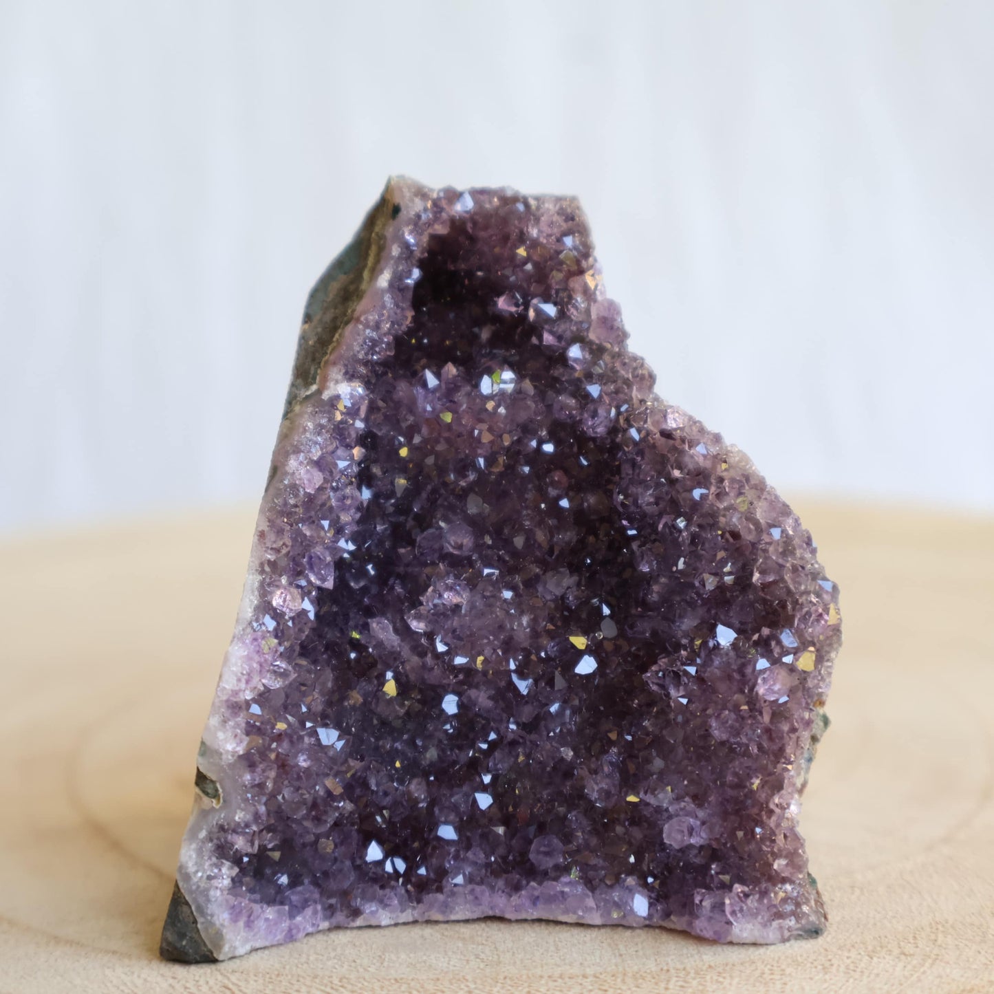 Small Amethyst cut base crystal formations with sparkling purple crystal clusters and freestanding polished base.