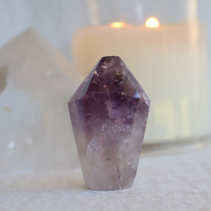 Small Amethyst generator with polished flat termination, deep purple upper section, clear quartz base, and natural internal inclusions