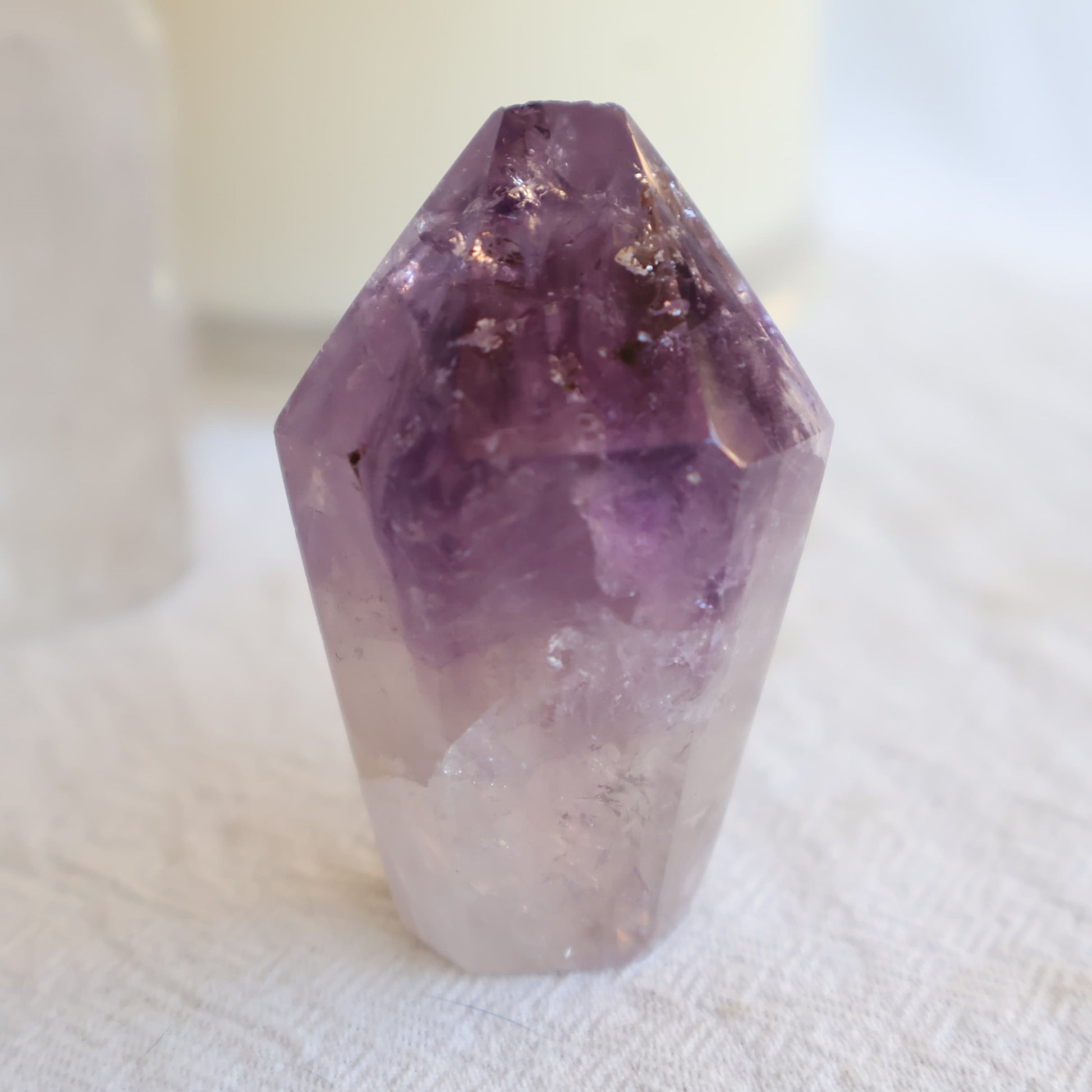 Small Amethyst generator with polished flat termination, deep purple upper section, clear quartz base, and natural internal inclusions