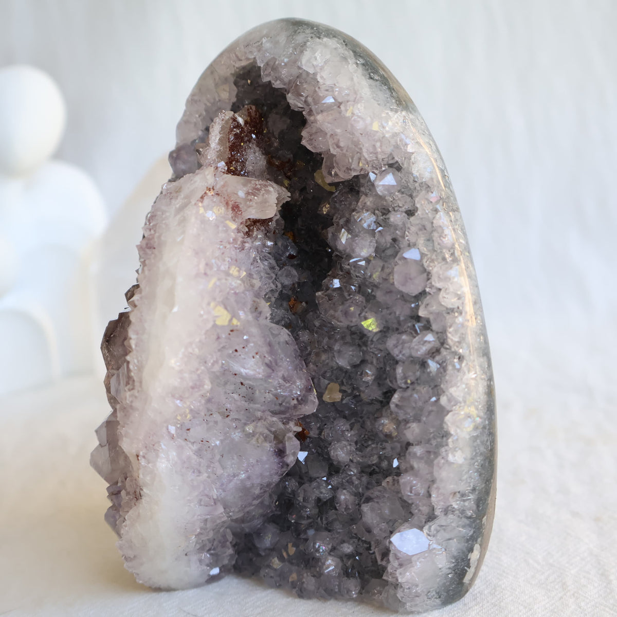 Amethyst cut base with natural Quartz crystal growth and Hematite inclusions, 12cm tall and weighing 807g.
