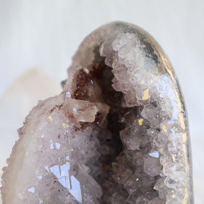 Amethyst cut base with natural Quartz crystal growth and Hematite inclusions, 12cm tall and weighing 807g.