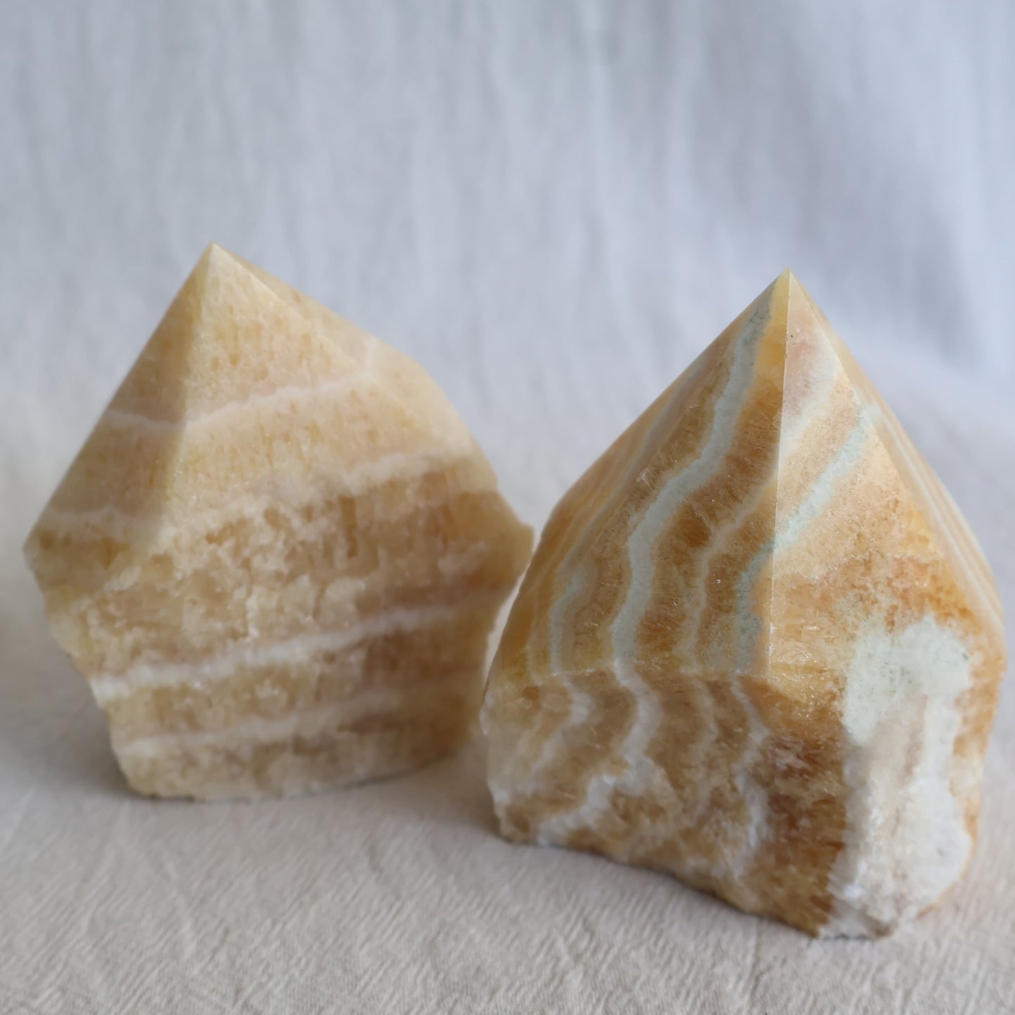 Banded Yellow Calcite polished point with warm golden-yellow tones and natural layered banding.