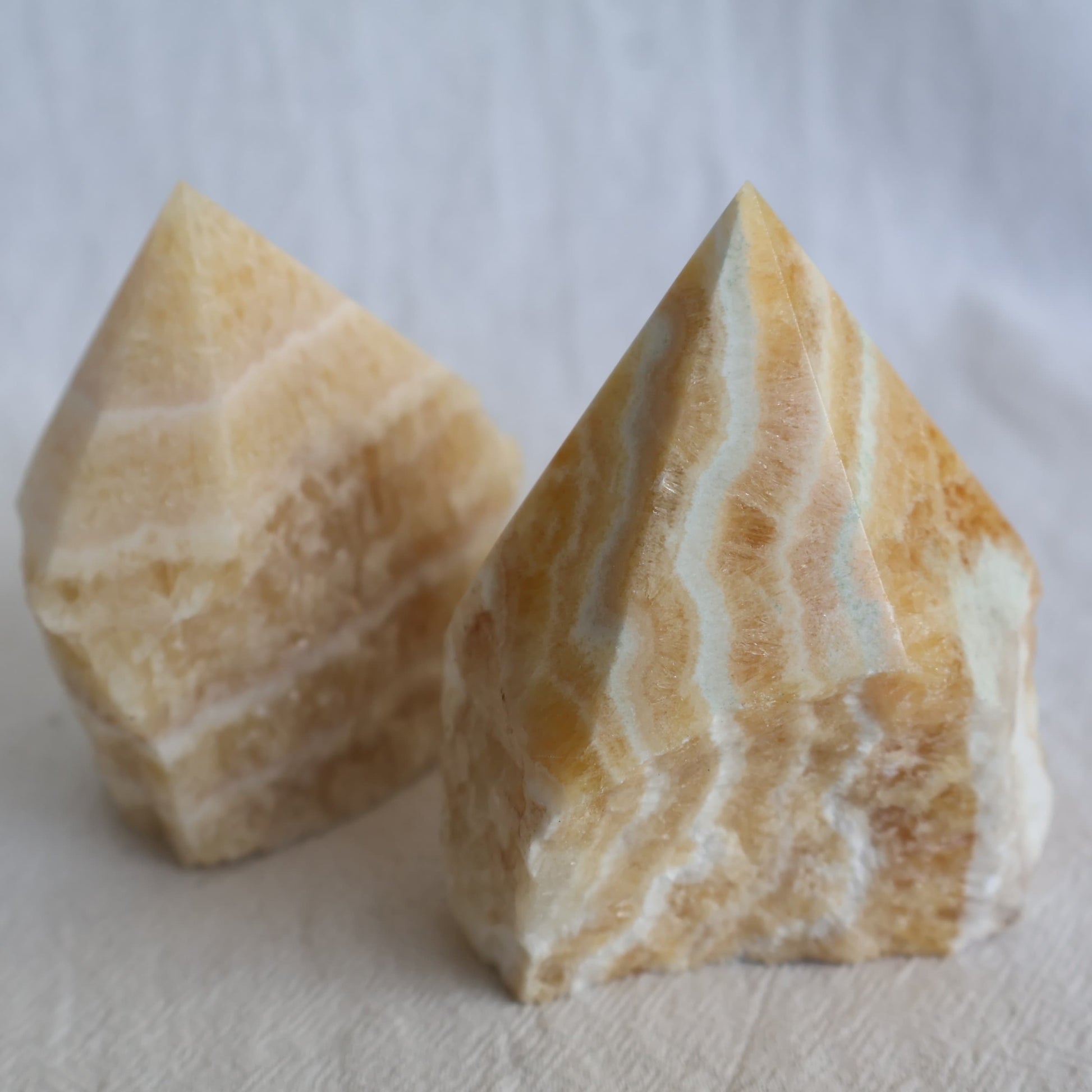 Banded Yellow Calcite polished point with warm golden-yellow tones and natural layered banding.