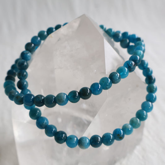 Natural Blue Apatite 5mm crystal bead bracelet in vibrant ocean blue tones with natural marbling on a stretch cord.