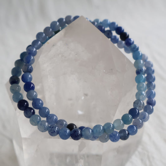 Natural Blue Aventurine 4mm crystal bead bracelet in soft denim blue tones with subtle natural shimmer on a stretch cord.