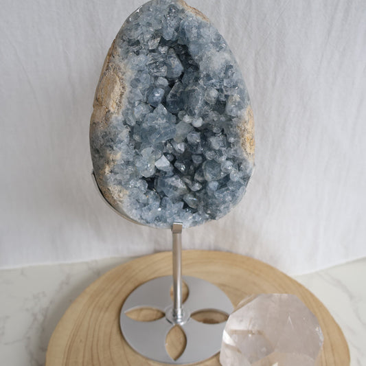 Large Blue Celestite crystal cluster on silver stand with soft blue natural formations, approximately 27cm tall and weighing 1.6kg.