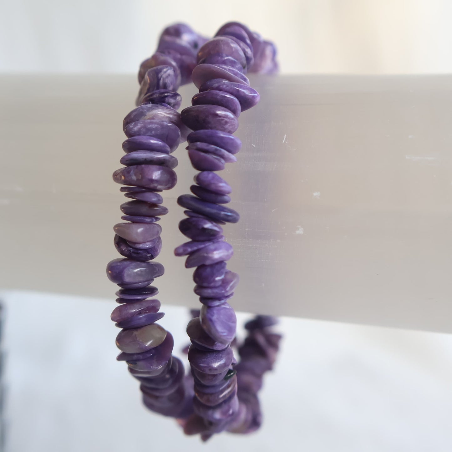 Charoite chip bracelet featuring natural polished chips in shades of violet, lavender and lilac on a stretch elastic band.