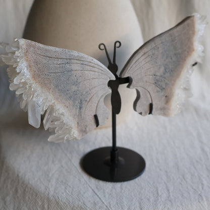 clear quartz butterfly with natural clusters on stand