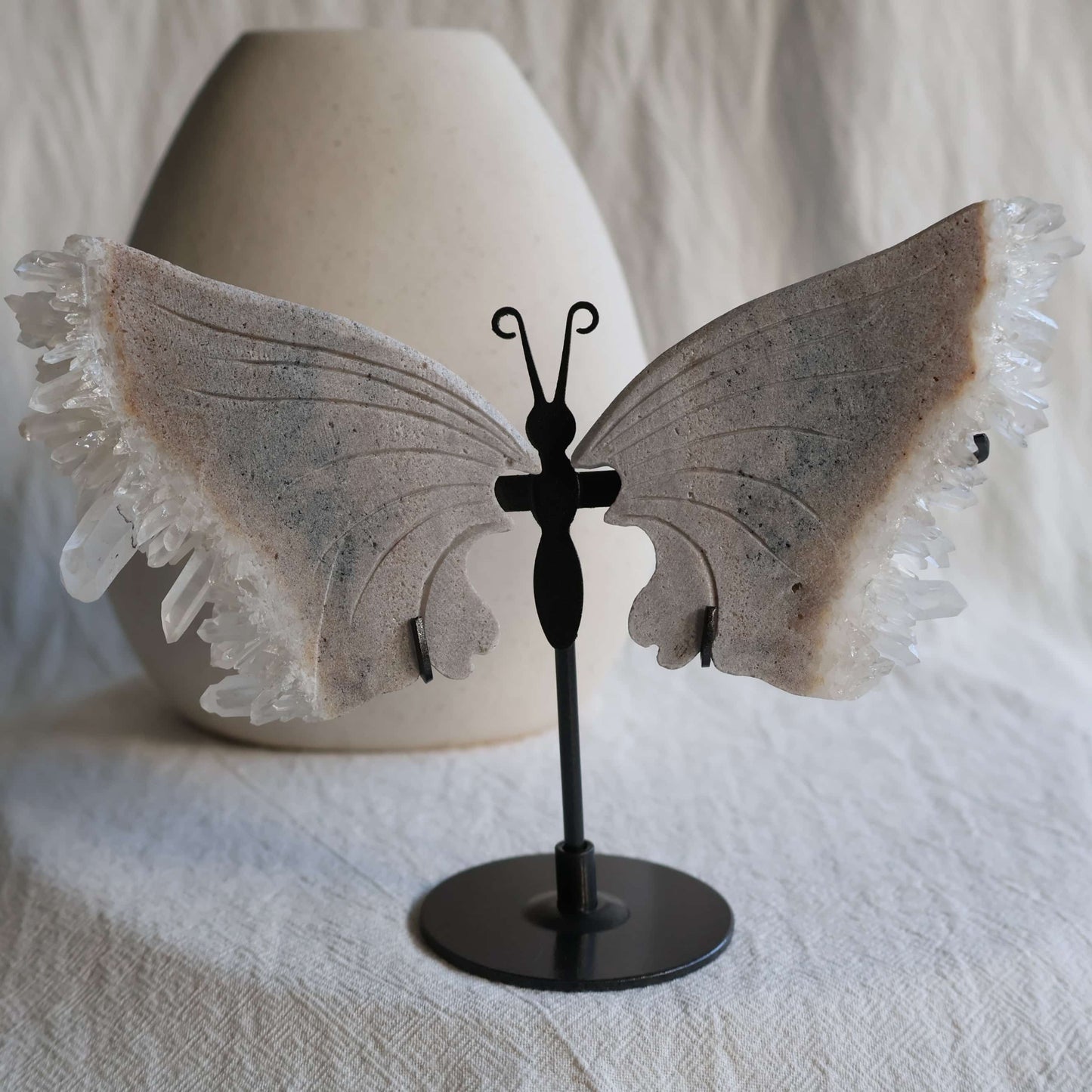 clear quartz butterfly with natural clusters on stand