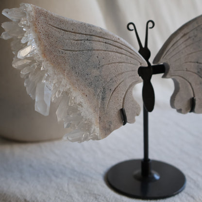 clear quartz butterfly with natural clusters on stand