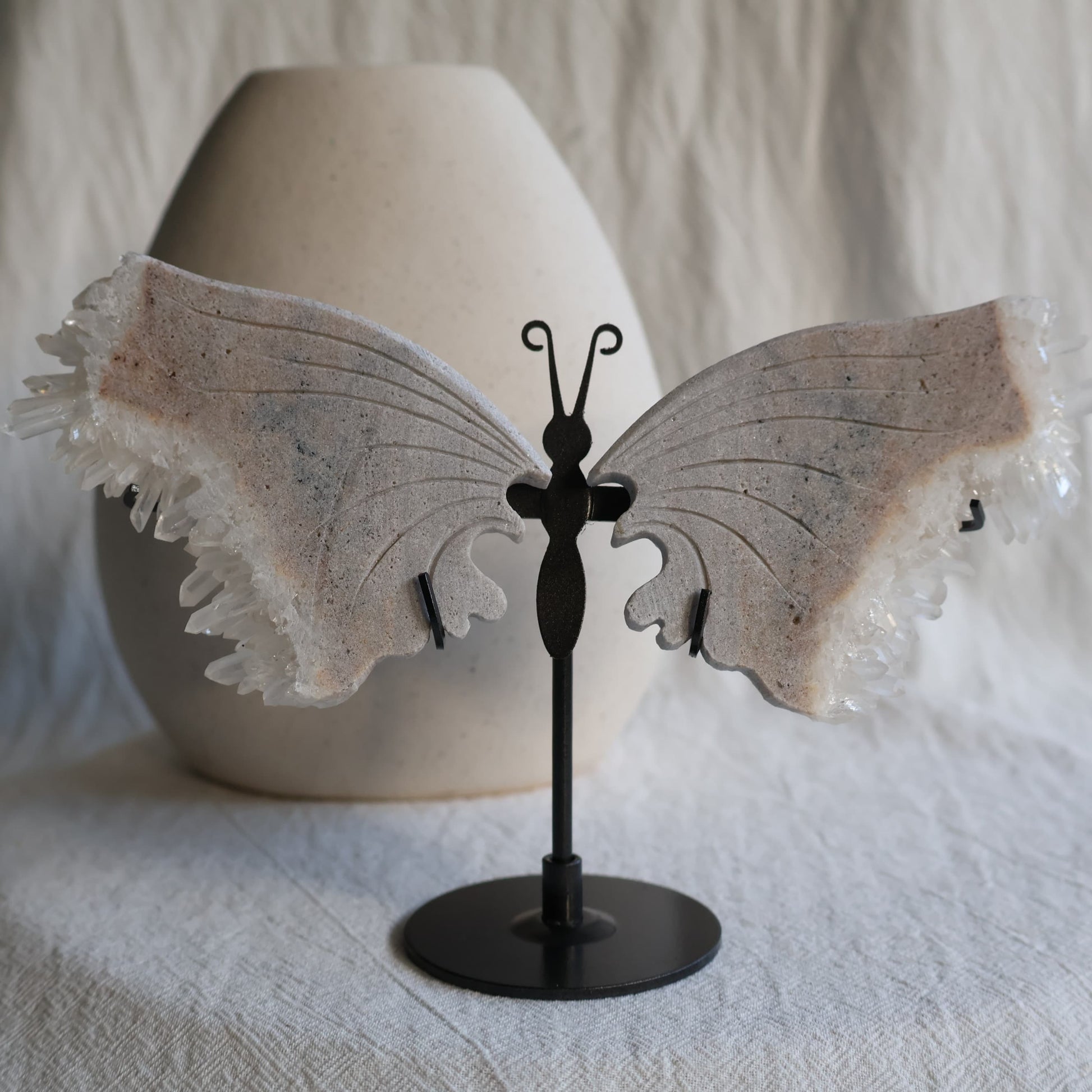 clear quartz butterfly with natural clusters on stand