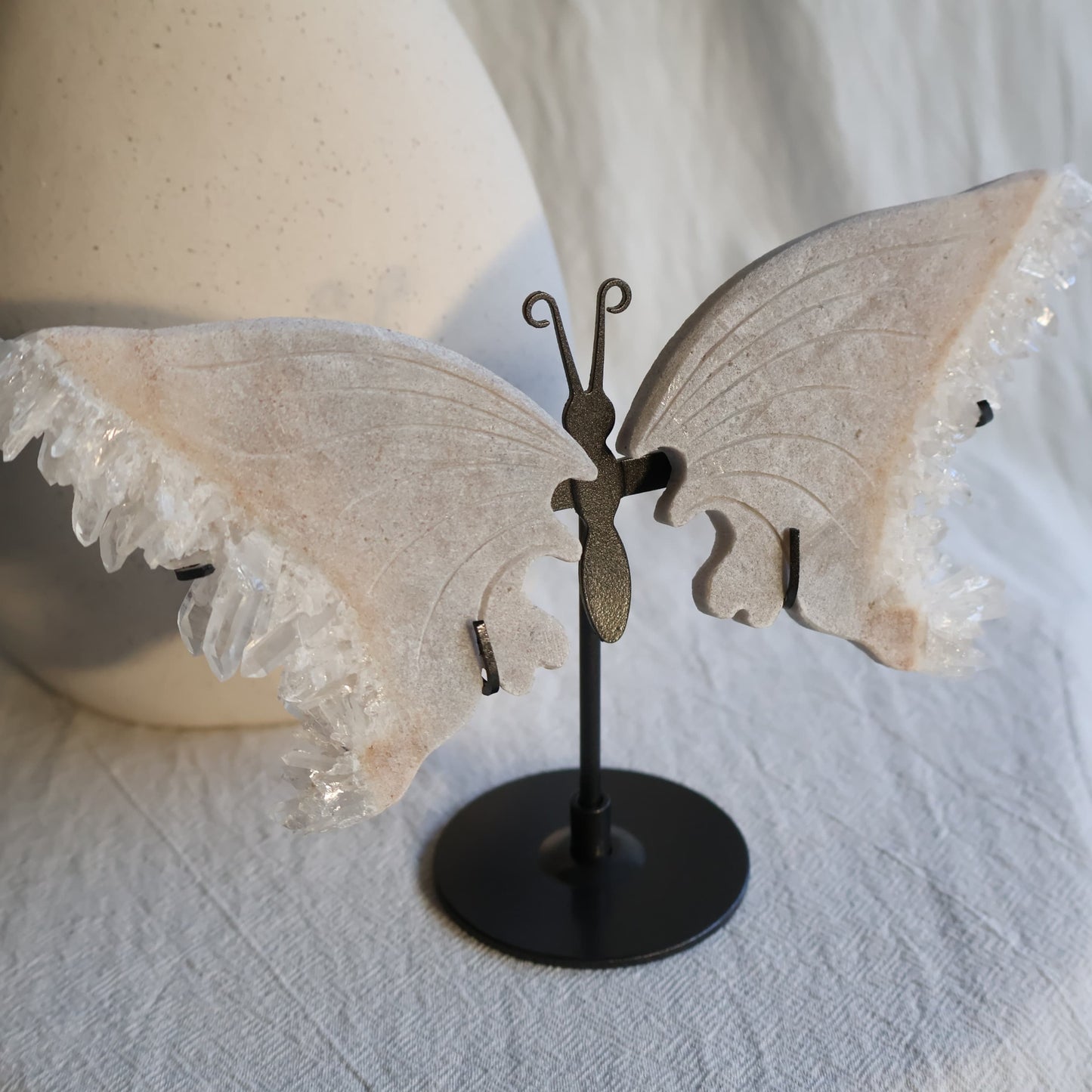 clear quartz butterfly with natural clusters on stand