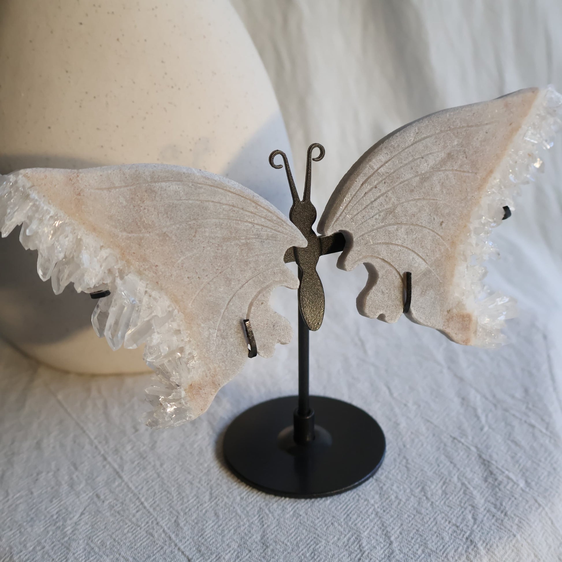 clear quartz butterfly with natural clusters on stand