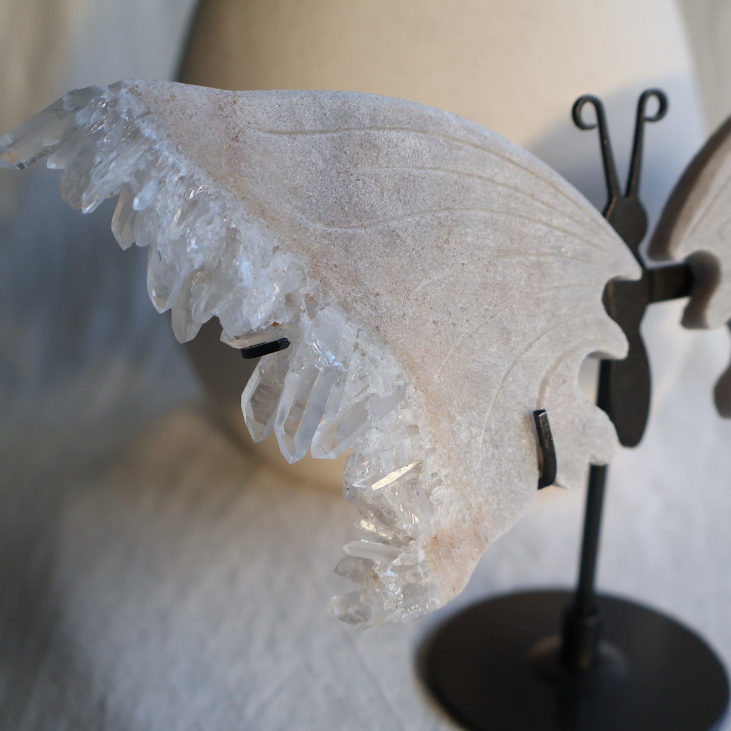 clear quartz butterfly with natural clusters on stand