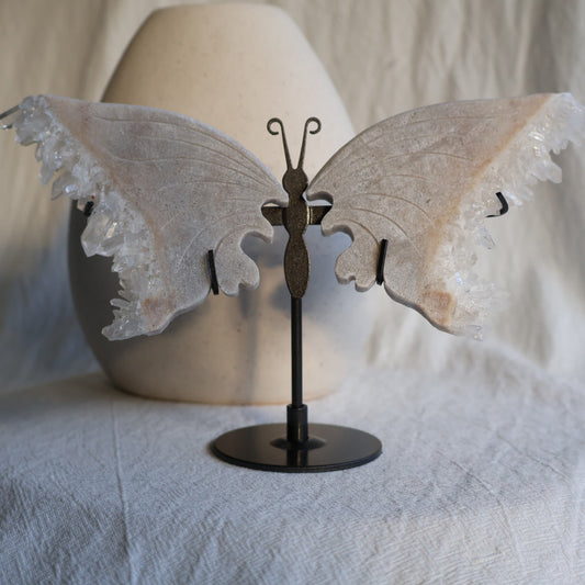 clear quartz butterfly with natural clusters on stand