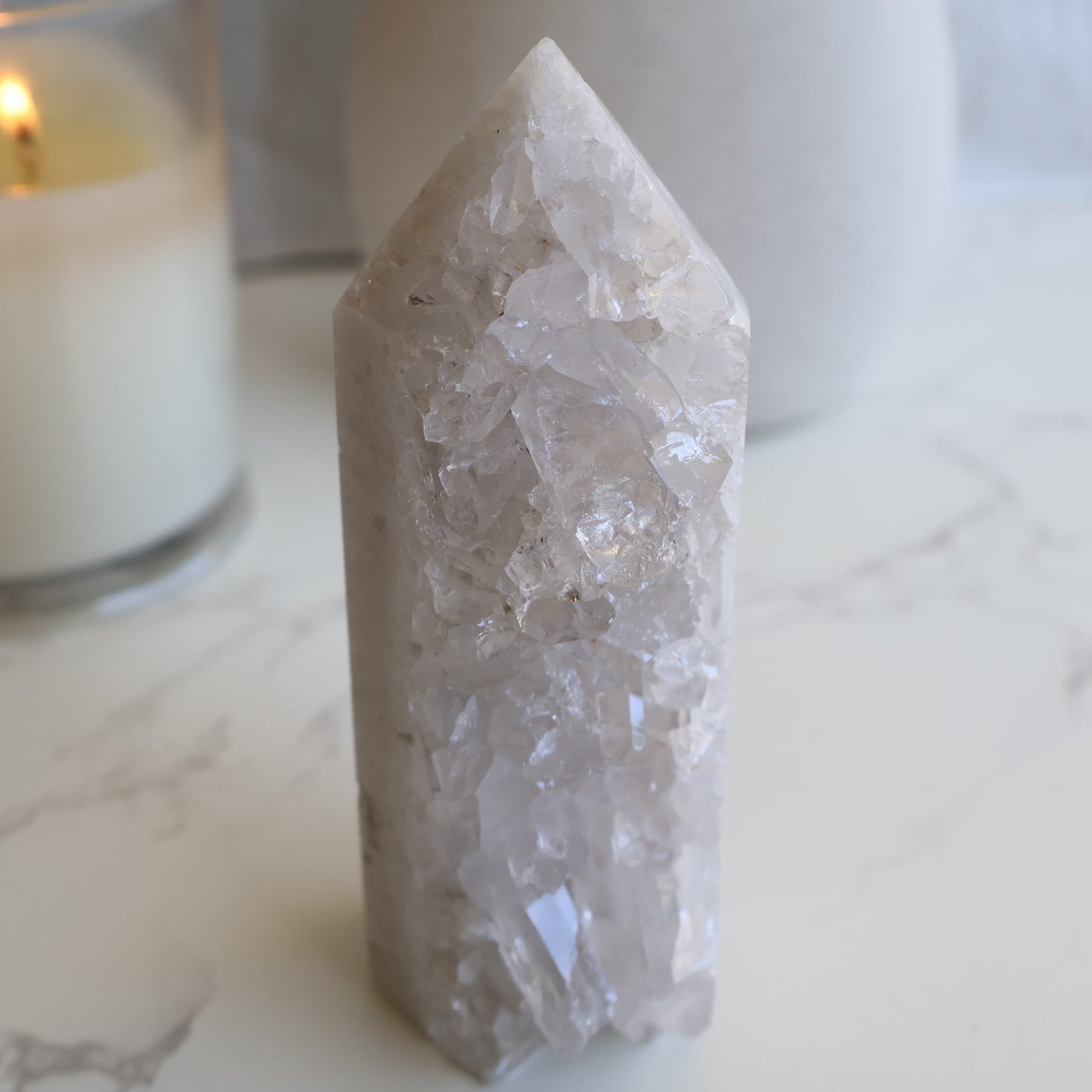 clear quartz cluster tower with natural raw crystal points and light reflective formation