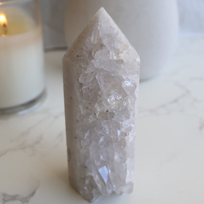 clear quartz cluster tower with natural raw crystal points and light reflective formation