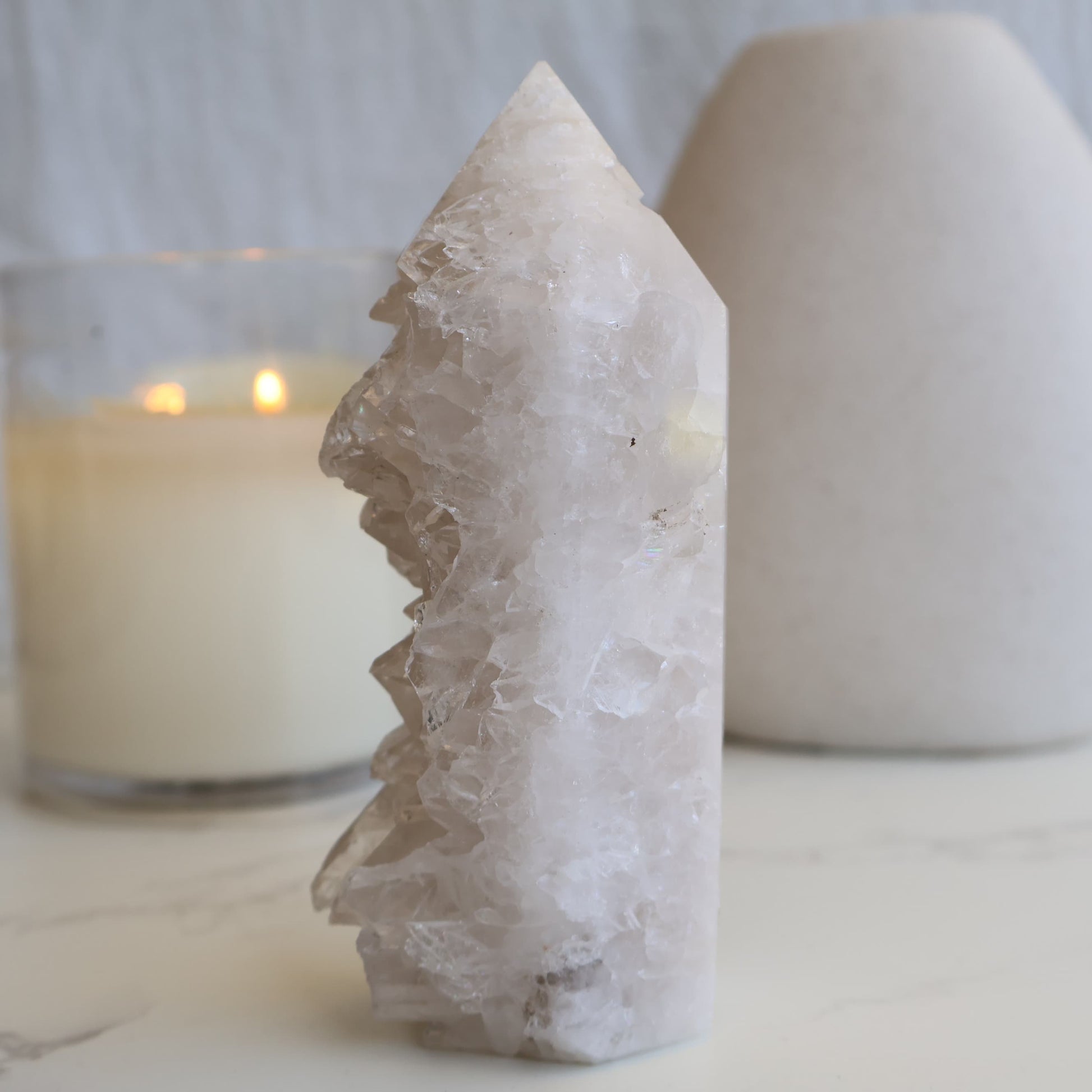 clear quartz cluster tower with natural raw crystal points and light reflective formation