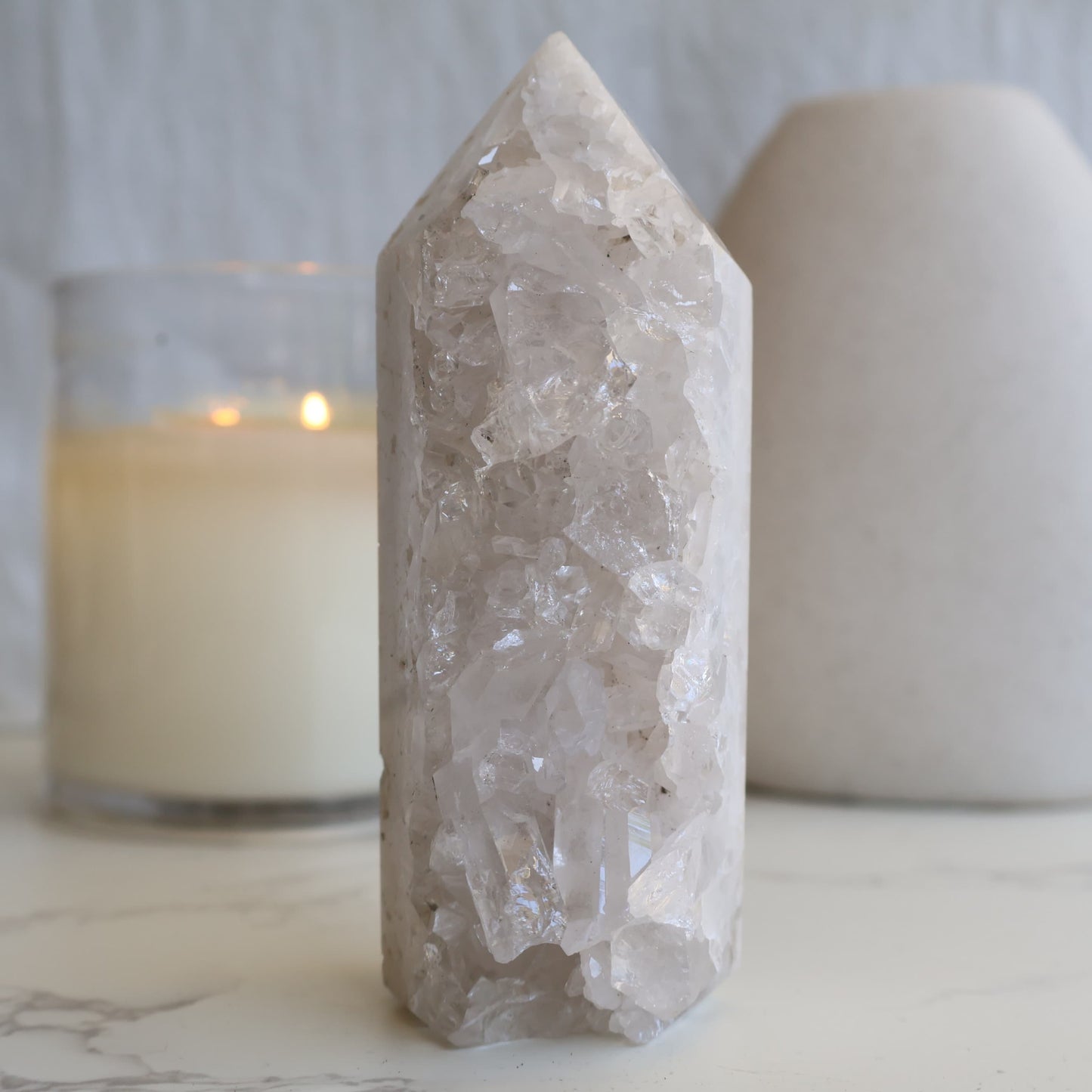 clear quartz cluster tower with natural raw crystal points and light reflective formation