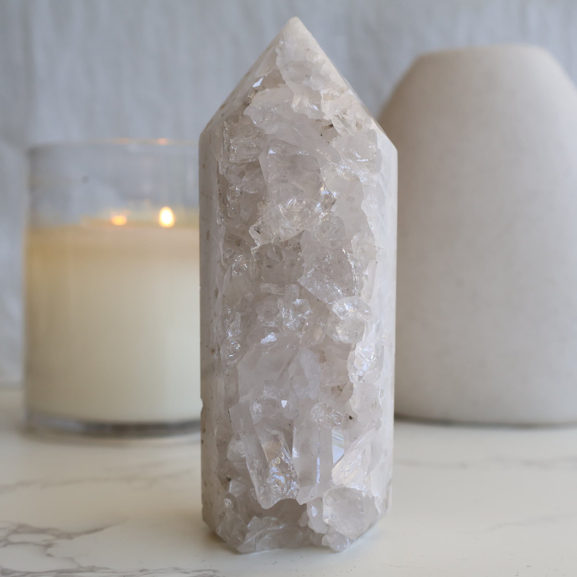 clear quartz cluster tower with natural raw crystal points and light reflective formation