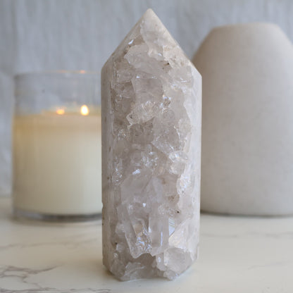 clear quartz cluster tower with natural raw crystal points and light reflective formation