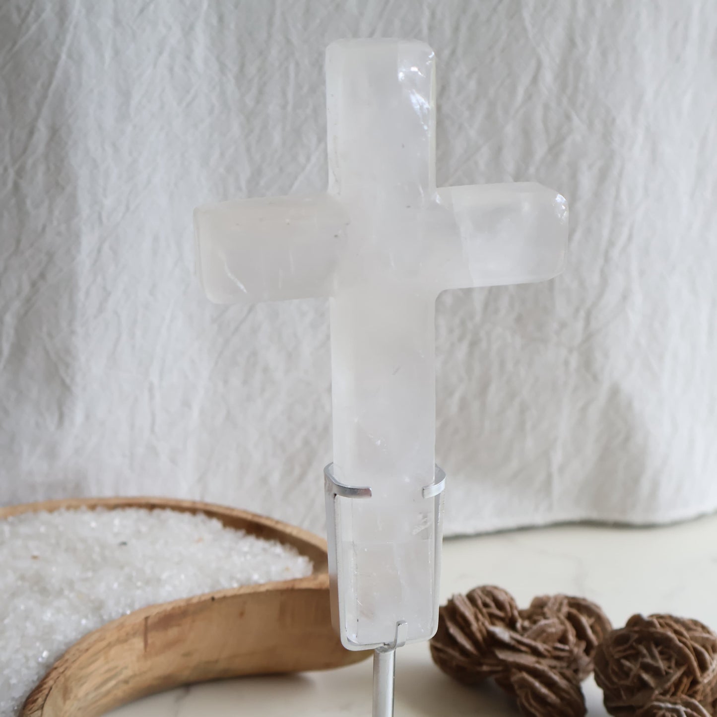 Clear Quartz cross carving with silver stand. A powerful crystal known for clarity, energy amplification, and balance.