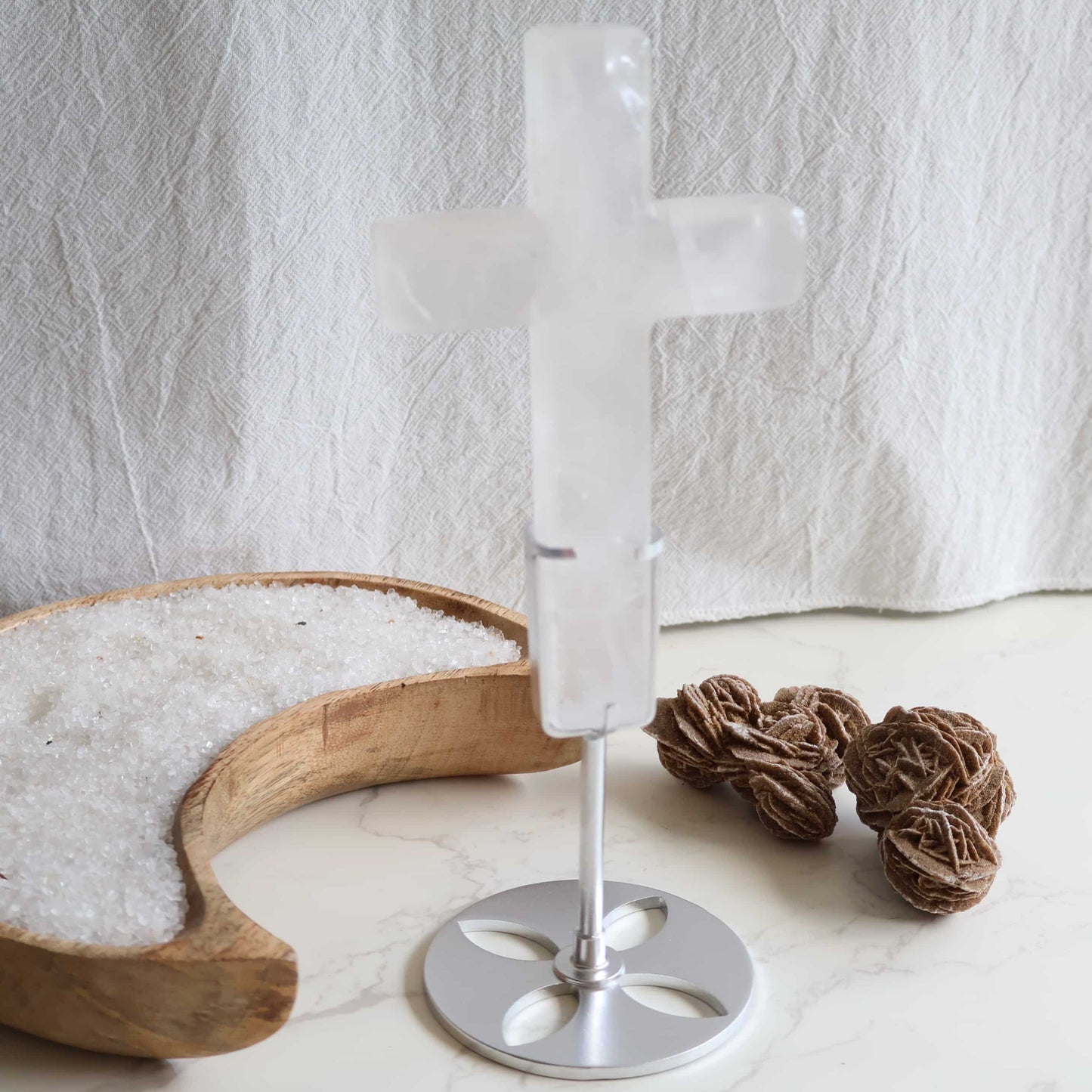 Clear Quartz cross carving with silver stand. A powerful crystal known for clarity, energy amplification, and balance.