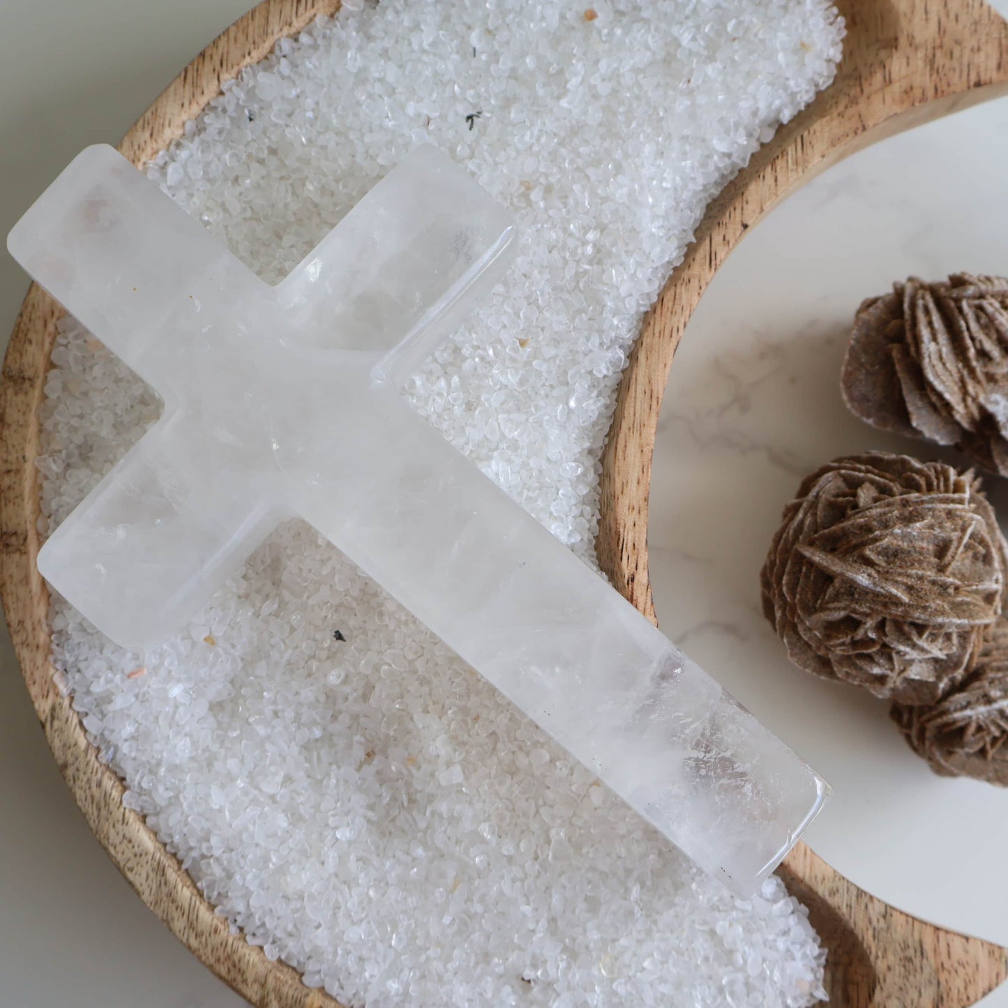 Clear Quartz cross carving with silver stand. A powerful crystal known for clarity, energy amplification, and balance.