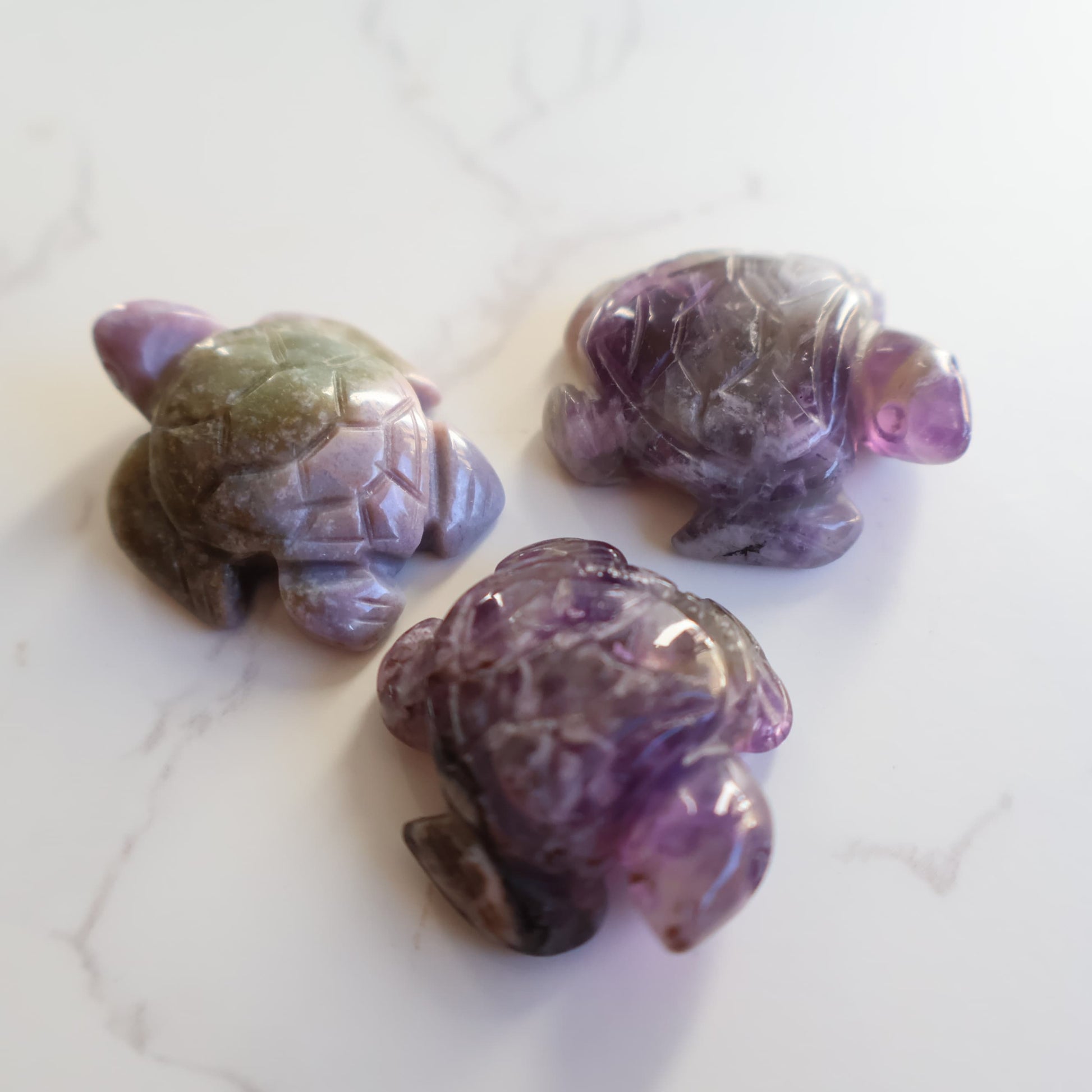 Mini crystal turtle carvings in Dream Amethyst, Green Aventurine and Tiger's Eye with polished finish and detailed shell carving.