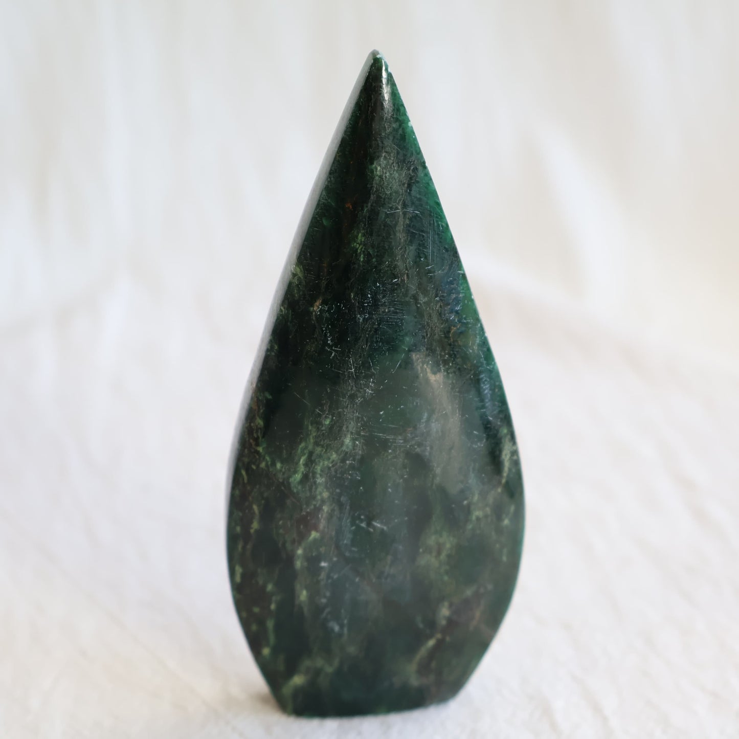 Natural Emerald crystal freeforms with deep green colouring, earthy inclusions and polished modern freeform shapes.