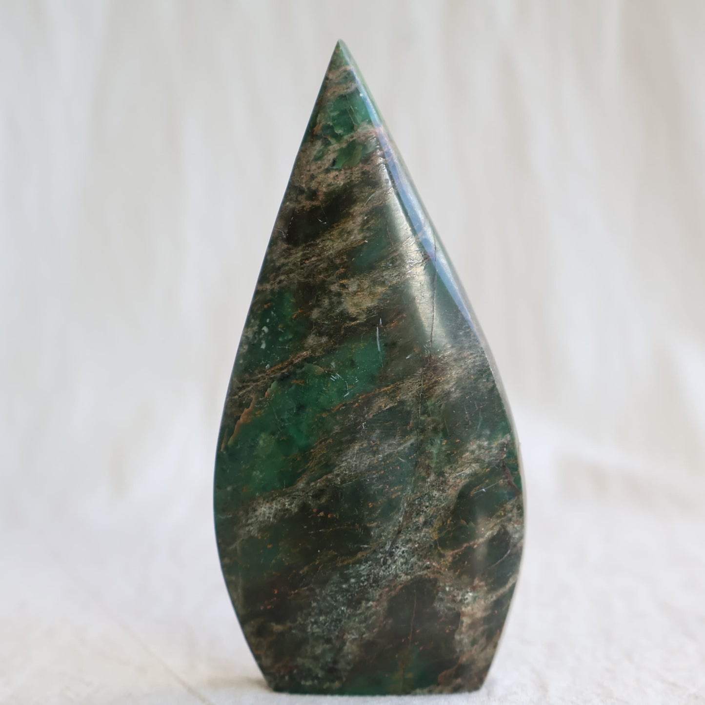 Natural Emerald crystal freeforms with deep green colouring, earthy inclusions and polished modern freeform shapes.