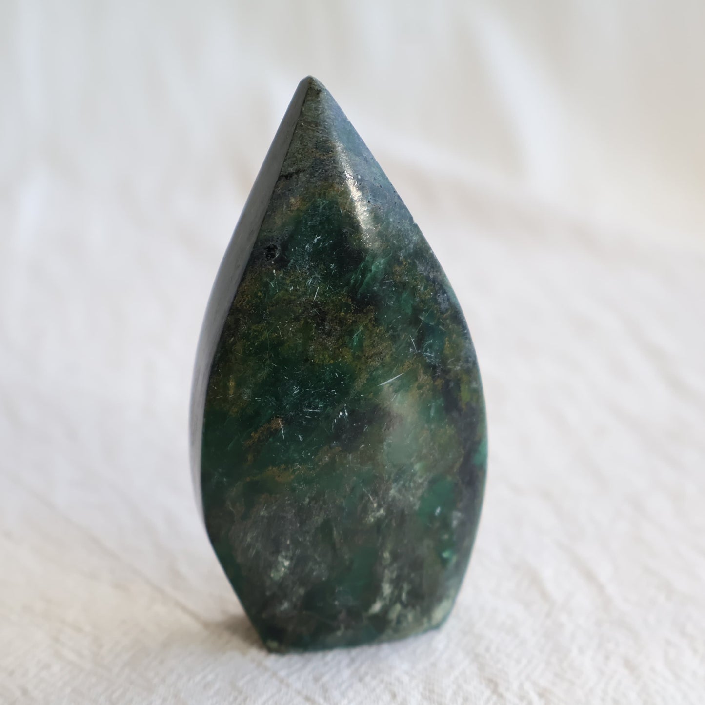 Natural Emerald crystal freeforms with deep green colouring, earthy inclusions and polished modern freeform shapes.