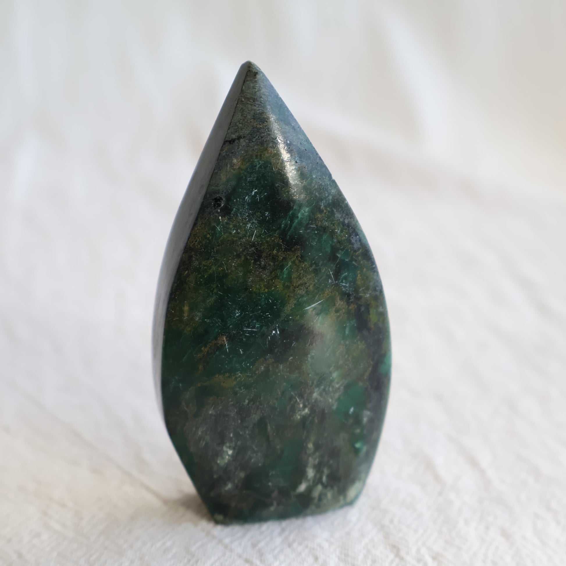 Natural Emerald crystal freeforms with deep green colouring, earthy inclusions and polished modern freeform shapes.