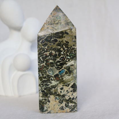 Epidote obelisk with natural Chrysocolla and copper inclusions, featuring earthy green, soft blue and metallic tones, 10.7cm tall.