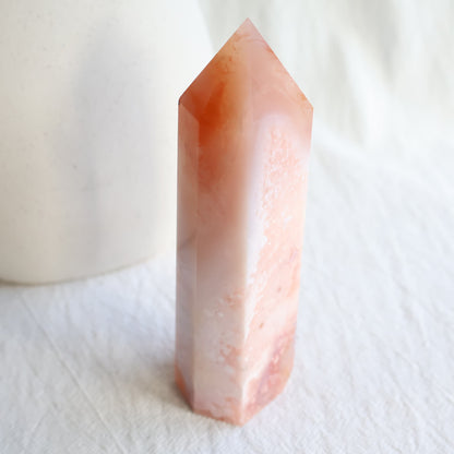 Flower Agate with Carnelian tower in soft pink and peach tones with white flower-like patterns and natural orange Carnelian inclusions