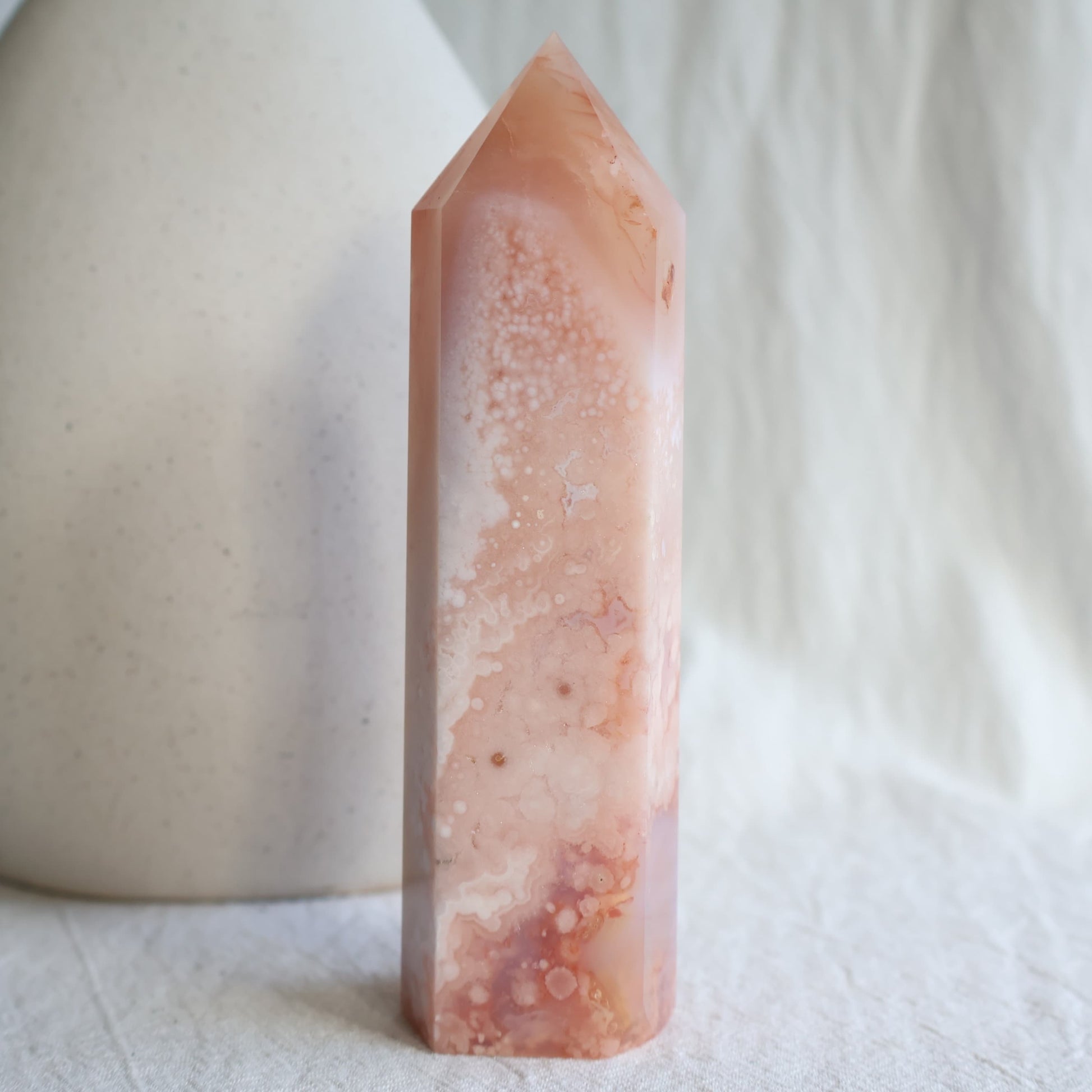 Flower Agate with Carnelian tower in soft pink and peach tones with white flower-like patterns and natural orange Carnelian inclusions