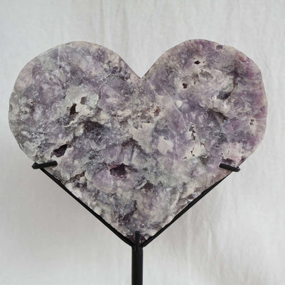 Large teal-green and purple Fluorite heart on black stand with a roughly polished face and contrasting raw lavender crystal reverse, 23cm tall.
