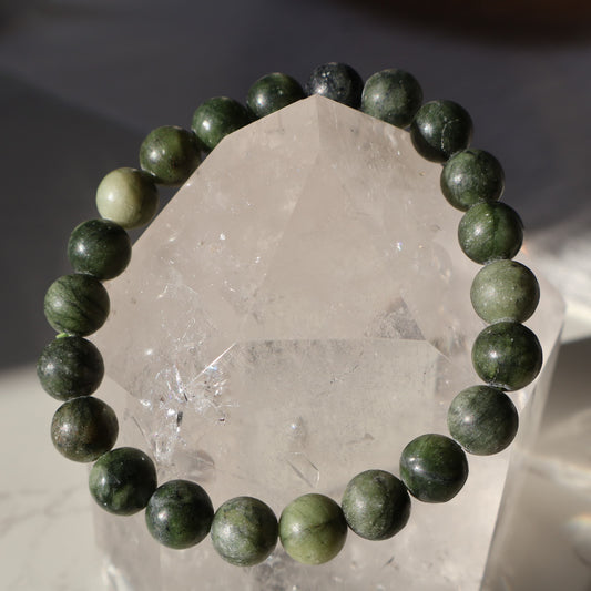 Green Jade 8mm bead stretch bracelet featuring smooth rich green beads with natural variations in colour.